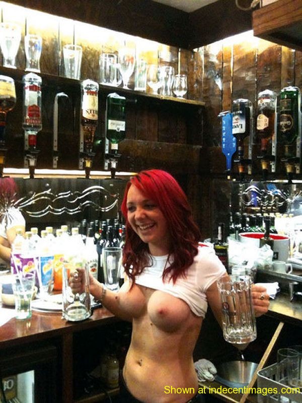 A busty barmaid shows off her tits